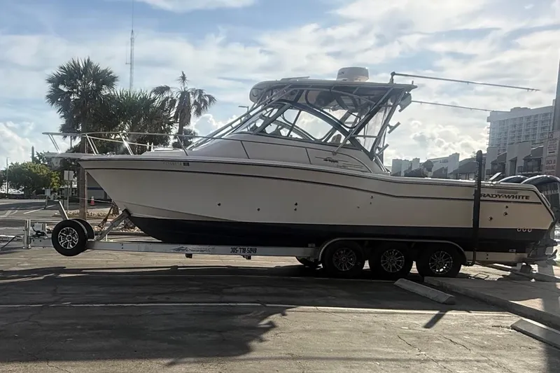  Yacht Photos Pics 2007 Grady-White Express 305 boat on trailer, parked outdoors under a partly cloudy sky.