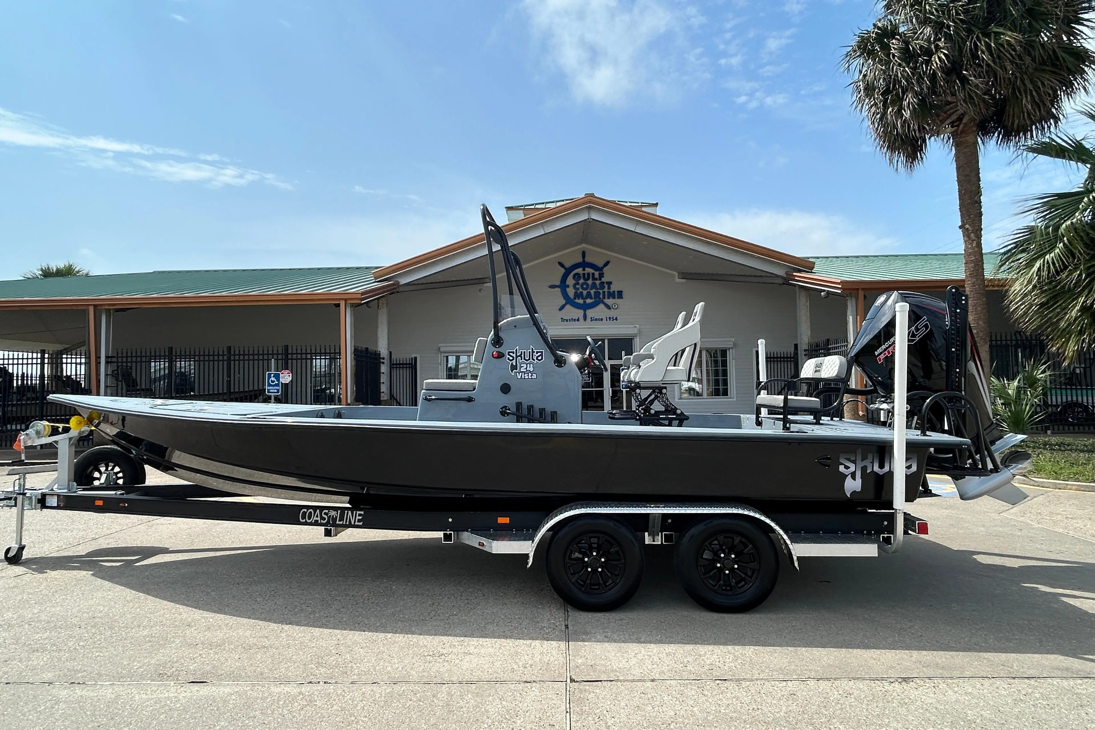 2026 Skuta 24 Vista boat on trailer, parked outside a marine dealership.