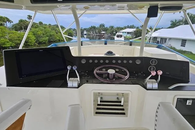 Andiamo Yacht Photos Pics Cockpit of 1991 Donzi 65 Sportfisher with steering wheel and control panel.