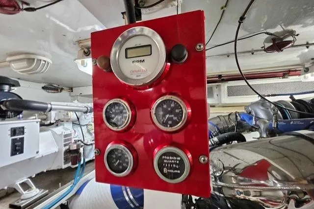Andiamo Yacht Photos Pics Red control panel in 1991 Donzi 65 Sportfisher engine room with gauges and meters.
