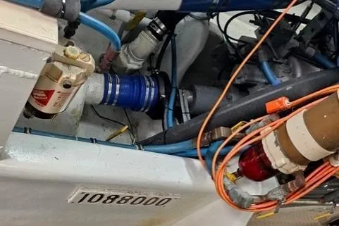 Andiamo Yacht Photos Pics Engine compartment of a 1991 Donzi 65 Sportfisher with visible wiring and components.