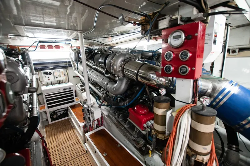 Andiamo Yacht Photos Pics Engine room of 1991 Donzi 65 Sportfisher, showcasing complex machinery and control panels.