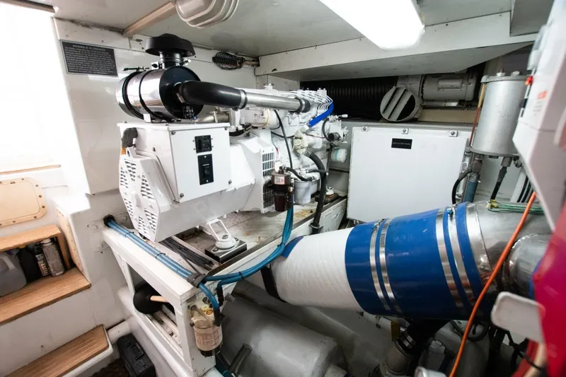 Andiamo Yacht Photos Pics Engine room of a 1991 Donzi 65 Sportfisher, showcasing mechanical components and equipment.