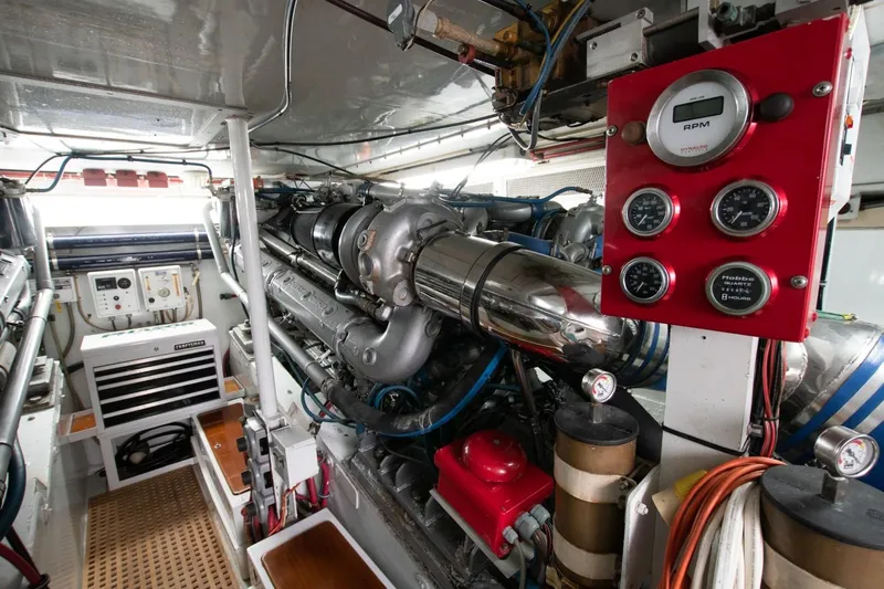 Andiamo Yacht Photos Pics Engine room of a 1991 Donzi 65 Sportfisher, featuring gauges and mechanical components.