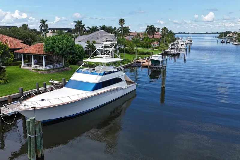 Andiamo Yacht Photos Pics 1991 Donzi 65 Sportfisher yacht docked in a scenic waterfront neighborhood.
