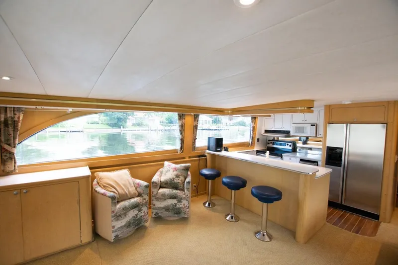 Andiamo Yacht Photos Pics Luxurious interior of 1991 Donzi 65 Sportfisher yacht with modern kitchen and seating area.