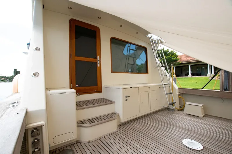 Andiamo Yacht Photos Pics 1991 Donzi 65 Sportfisher yacht deck with wooden door and ladder.