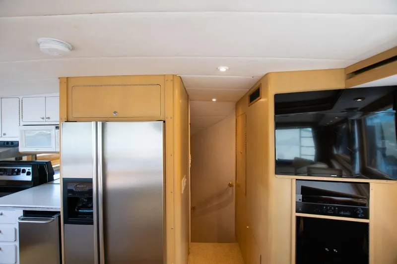 Andiamo Yacht Photos Pics Interior of 1991 Donzi 65 Sportfisher yacht with modern kitchen and entertainment area.