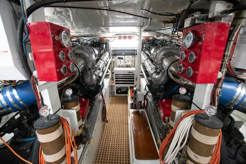Andiamo Yacht Photos Pics Engine room of a 1991 Donzi 65 Sportfisher, featuring dual engines and control panels.