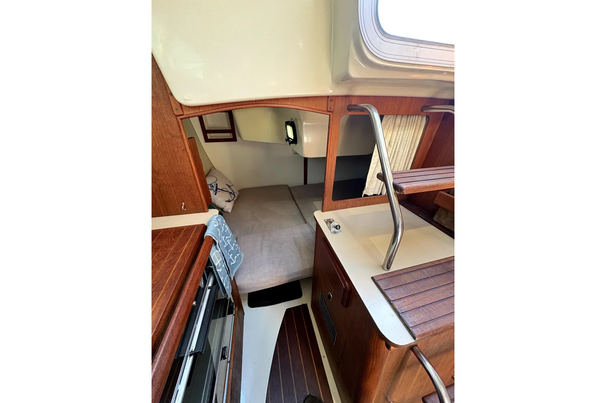 Interior of 1989 Hunter 30 sailboat, featuring cozy cabin with wood accents and compact layout.