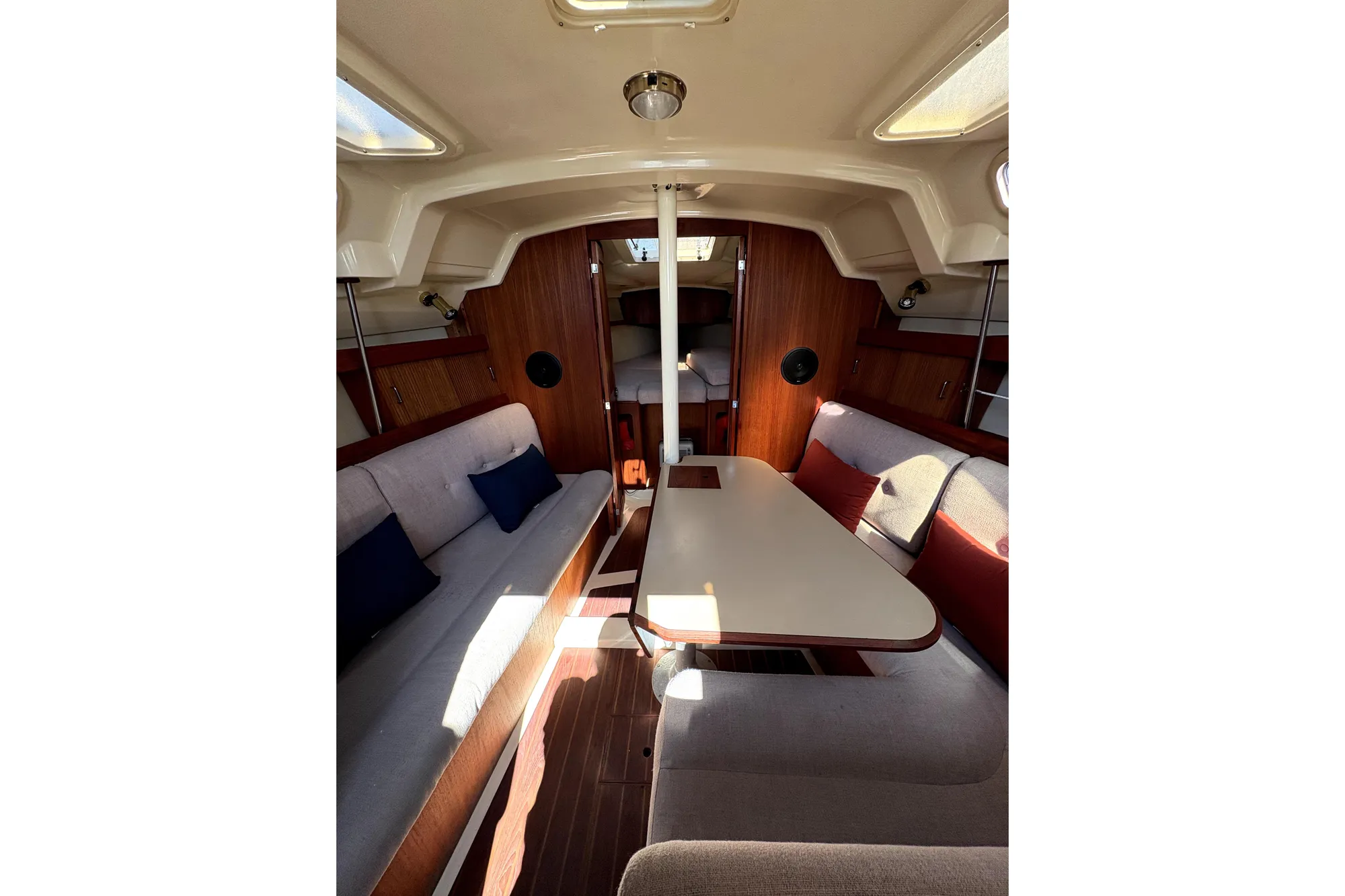 Interior of 1989 Hunter 30 sailboat with cozy seating and wooden accents.