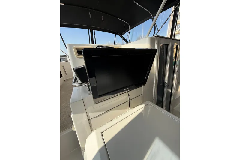 Il Danza Yacht Photos Pics 1999 Carver 406 Aft Cabin Motor Yacht interior with mounted TV and modern design.