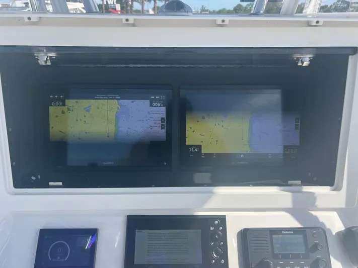  Yacht Photos Pics Dashboard of a 2021 Contender 32 ST boat with Garmin navigation displays.