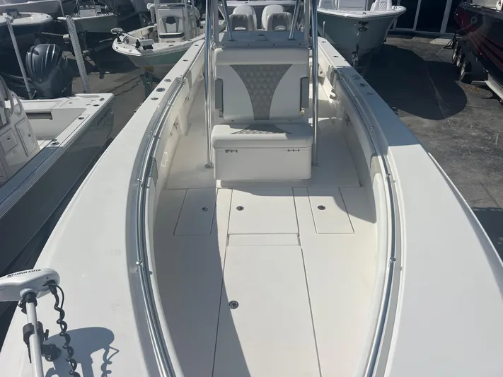  Yacht Photos Pics 2021 Contender 32 ST boat, white interior, docked among other boats.