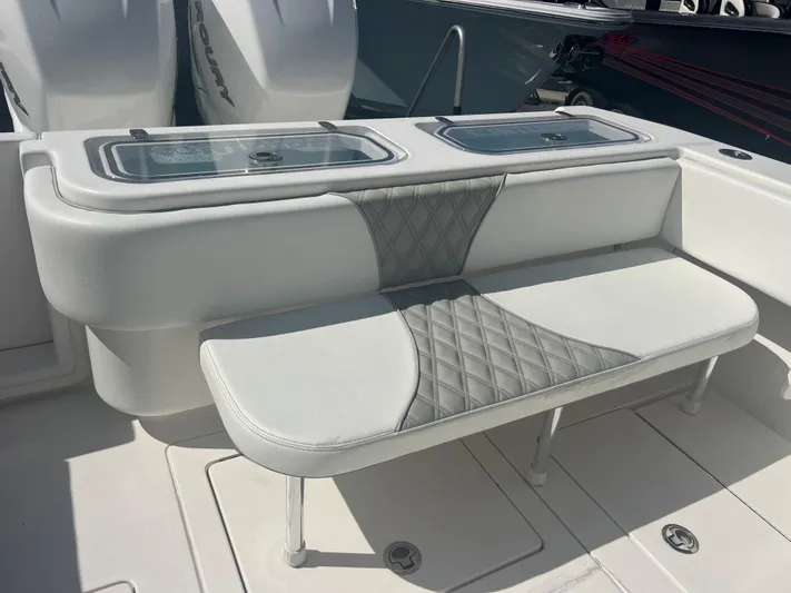  Yacht Photos Pics 2021 Contender 32 ST boat with cushioned seating and storage compartments.