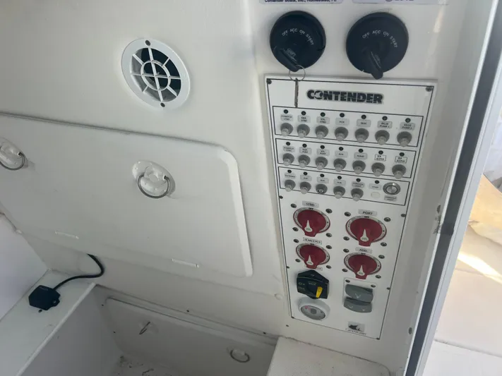  Yacht Photos Pics Control panel of a 2021 Contender 32 ST boat with switches and dials.