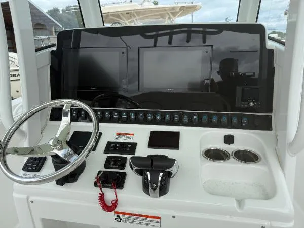 30-064 Brokerage Ron Yacht Photos Pics 2021 Sea Hunt Gamefish 30 dashboard with steering wheel, dual screens, and controls.