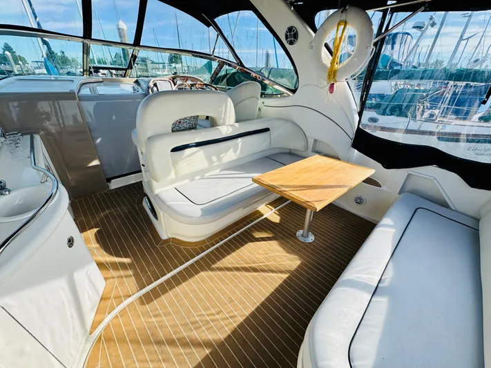 Tranquilo Yacht Photos Pics Interior of 2004 Sea Ray 360 Sundancer yacht with seating and wooden table.