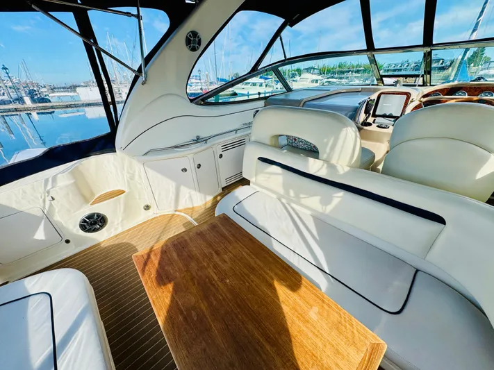 Tranquilo Yacht Photos Pics Interior of 2004 Sea Ray 360 Sundancer yacht with elegant seating and wooden table.
