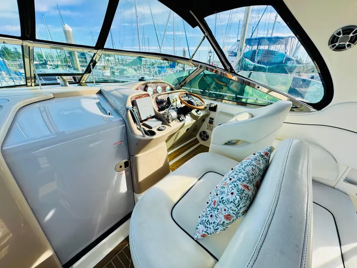 Tranquilo Yacht Photos Pics 2004 Sea Ray 360 Sundancer cockpit with plush seating and modern controls, docked at marina.