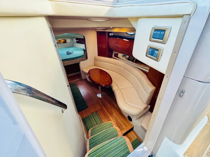 Tranquilo Yacht Photos Pics Interior of 2004 Sea Ray 360 Sundancer yacht with seating and table.