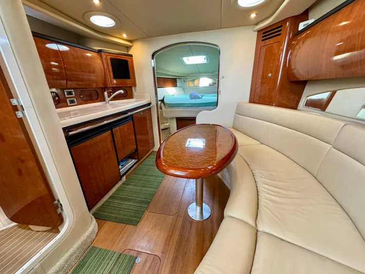 Tranquilo Yacht Photos Pics Luxurious interior of 2004 Sea Ray 360 Sundancer yacht with kitchen and seating area.