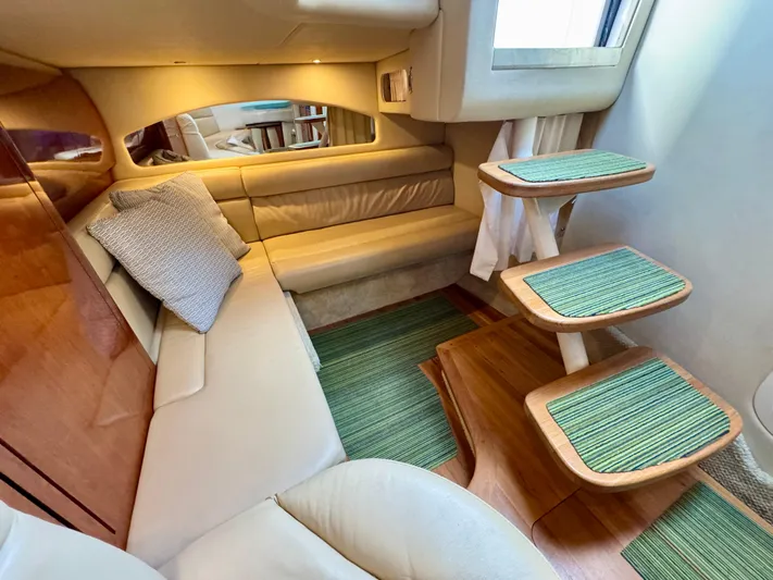 Tranquilo Yacht Photos Pics Interior of 2004 Sea Ray 360 Sundancer with beige seating and wooden steps.