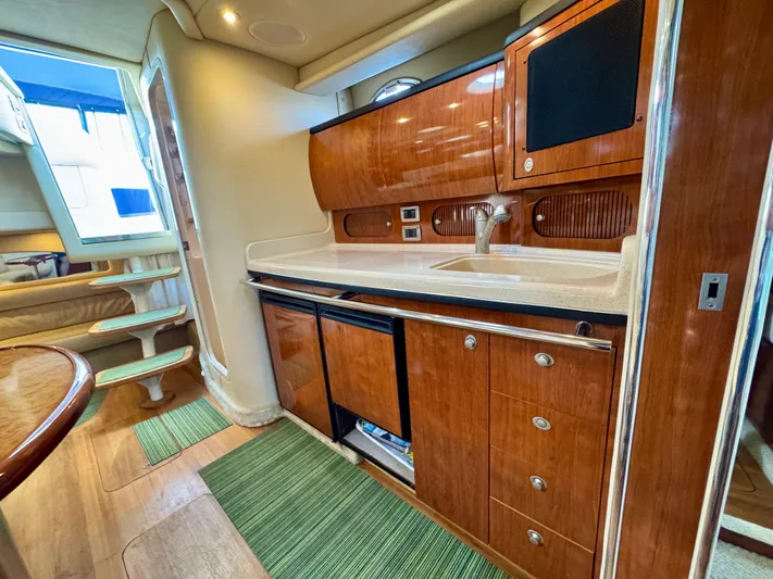 Tranquilo Yacht Photos Pics 2004 Sea Ray 360 Sundancer interior kitchen with wood cabinetry and modern amenities.