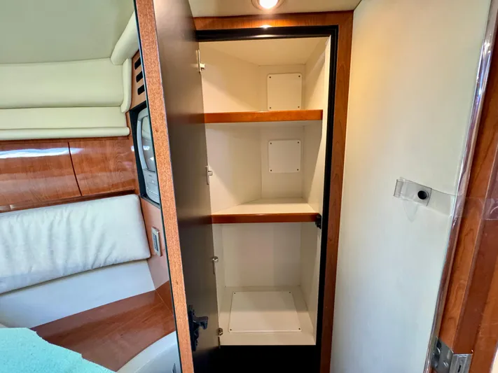 Tranquilo Yacht Photos Pics 2004 Sea Ray 360 Sundancer interior with open wooden cabinet and shelves.