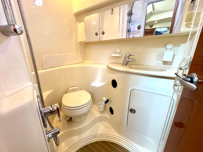 Tranquilo Yacht Photos Pics 2004 Sea Ray 360 Sundancer bathroom with toilet, sink, and storage cabinets.