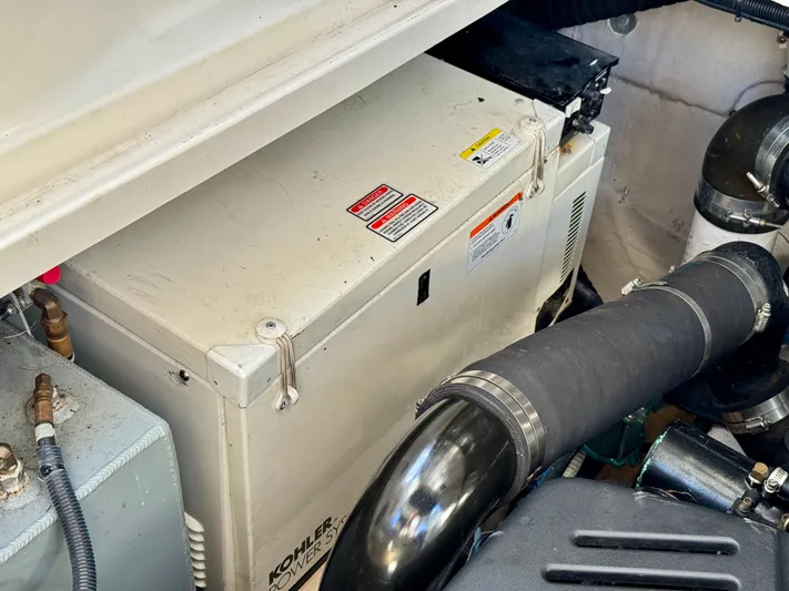 Tranquilo Yacht Photos Pics Engine compartment of 2004 Sea Ray 360 Sundancer with Kohler generator visible.