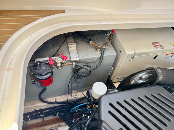 Tranquilo Yacht Photos Pics Engine compartment of a 2004 Sea Ray 360 Sundancer boat, showing mechanical components.