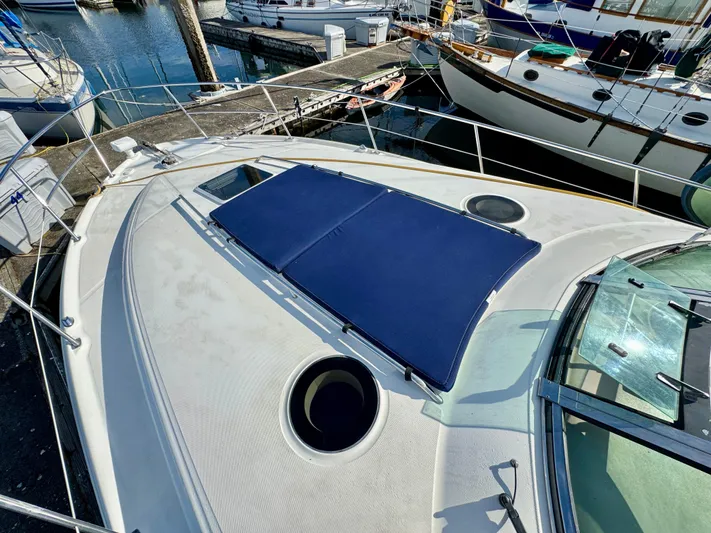 Tranquilo Yacht Photos Pics 2004 Sea Ray 360 Sundancer yacht deck with sun pad, docked at marina.