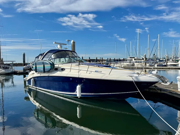 Tranquilo Yacht Photos Pics 2004 Sea Ray 360 Sundancer yacht docked in a marina under a clear blue sky.