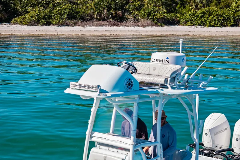  Yacht Photos Pics 2023 Barker Boatworks 26 Open on turquoise water near a sandy beach.