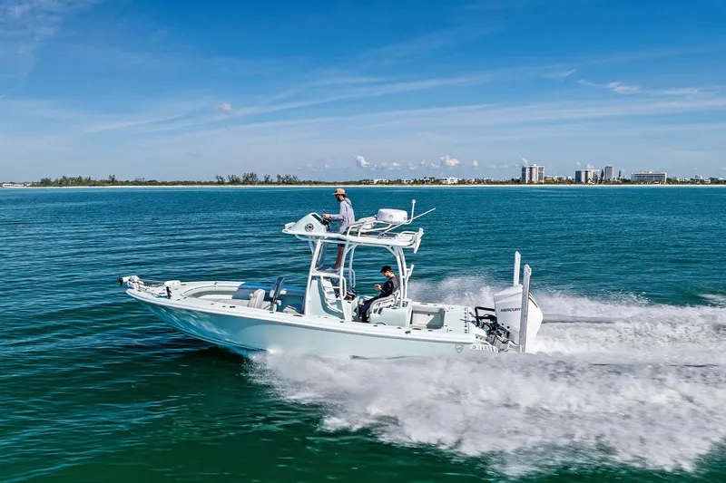  Yacht Photos Pics 2023 Barker Boatworks 26 Open cruising on clear blue water near a distant shoreline.
