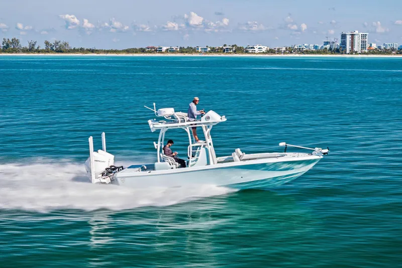  Yacht Photos Pics 2023 Barker Boatworks 26 Open cruising on clear blue water near a distant shoreline.
