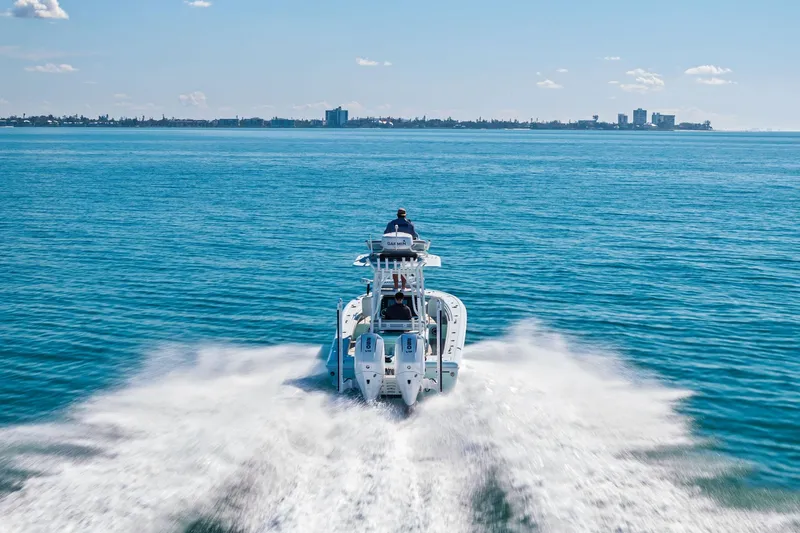  Yacht Photos Pics 2023 Barker Boatworks 26 Open cruising on open water, city skyline in background.