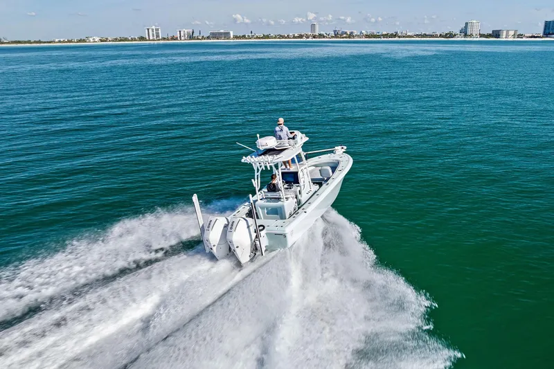  Yacht Photos Pics 2023 Barker Boatworks 26 Open cruising on open water, city skyline in background.
