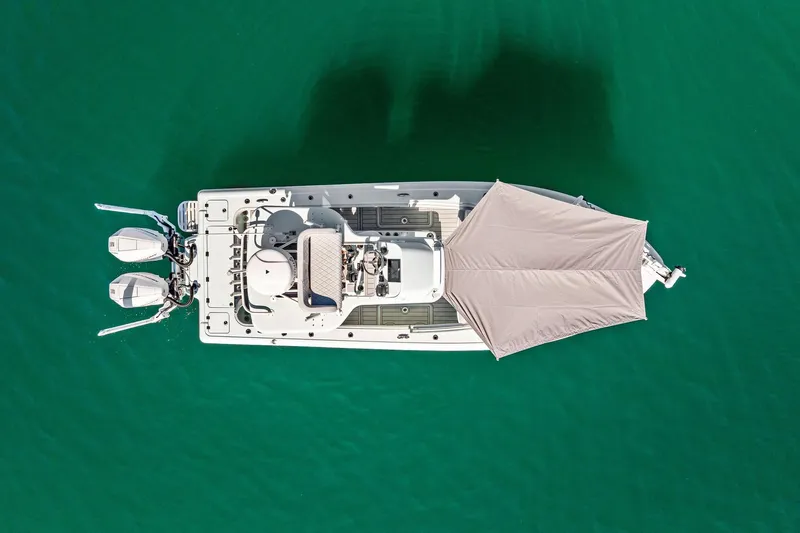  Yacht Photos Pics Aerial view of 2023 Barker Boatworks 26 Open on turquoise water.