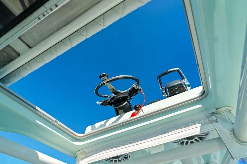  Yacht Photos Pics 2023 Barker Boatworks 26 Open steering wheel and controls under clear blue sky.