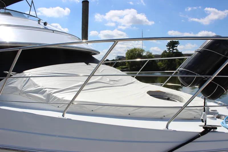  Yacht Photos Pics 2003 Carver 36 Super Sport yacht with covered deck, docked under a sunny sky.