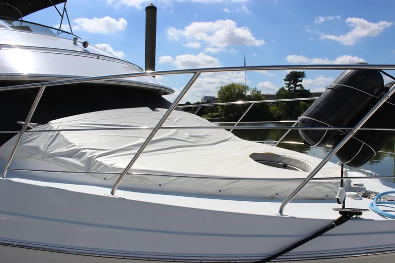  Yacht Photos Pics 2003 Carver 36 Super Sport yacht with covered deck, docked under a sunny sky.