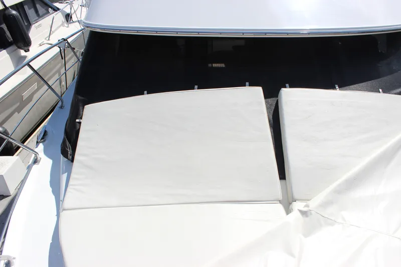  Yacht Photos Pics 2003 Carver 36 Super Sport yacht with white deck cushions and railing.