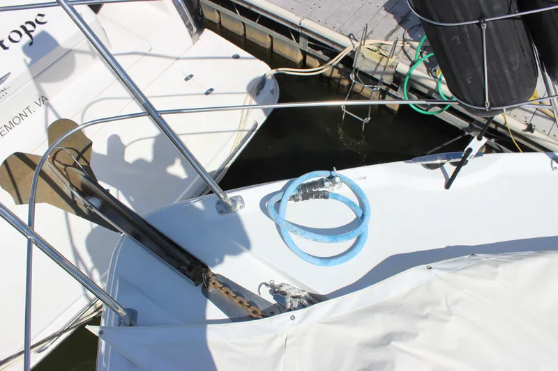  Yacht Photos Pics 2003 Carver 36 Super Sport yacht bow with anchor and blue hose at dock.