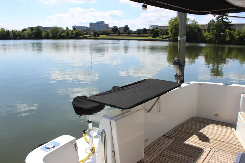  Yacht Photos Pics 2003 Carver 36 Super Sport yacht on a serene lake with scenic views.