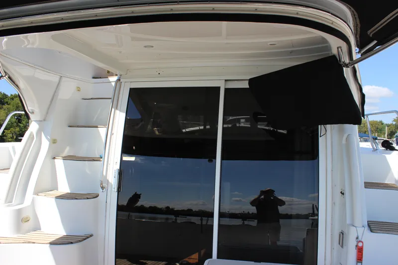  Yacht Photos Pics 2003 Carver 36 Super Sport yacht with sliding glass doors and exterior stairs.