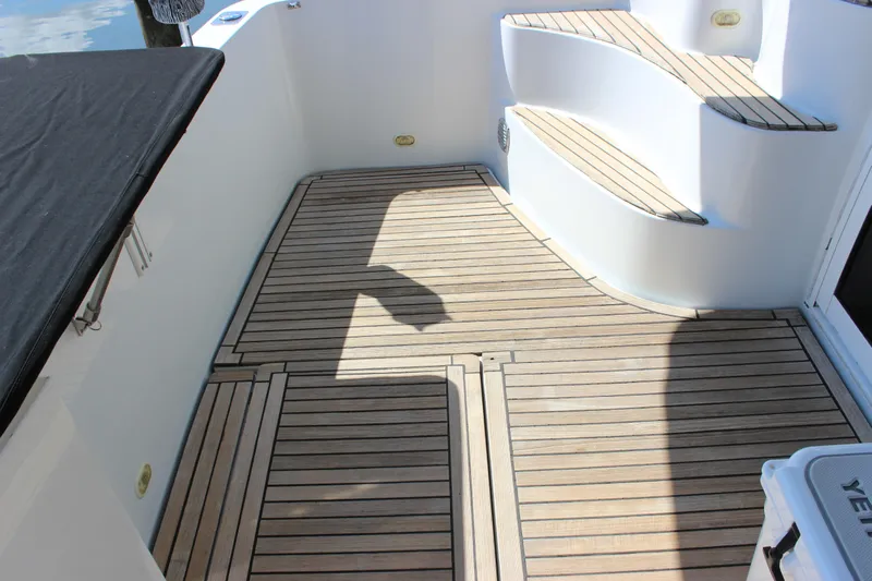  Yacht Photos Pics 2003 Carver 36 Super Sport yacht deck with wooden flooring and steps.
