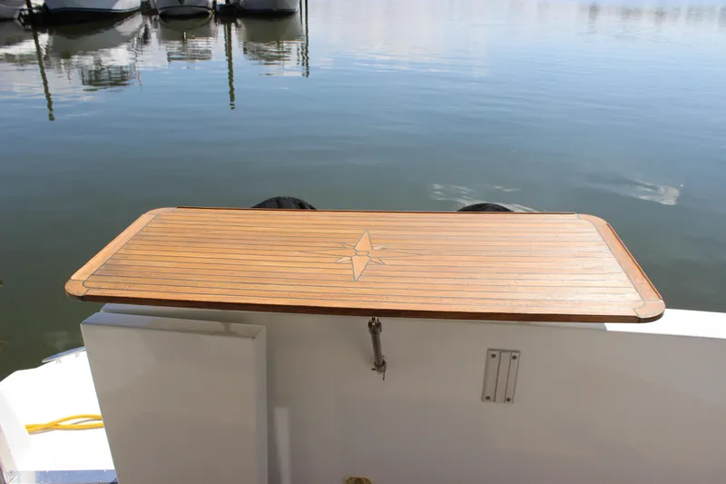  Yacht Photos Pics Teak swim platform on 2003 Carver 36 Super Sport, docked by calm water.