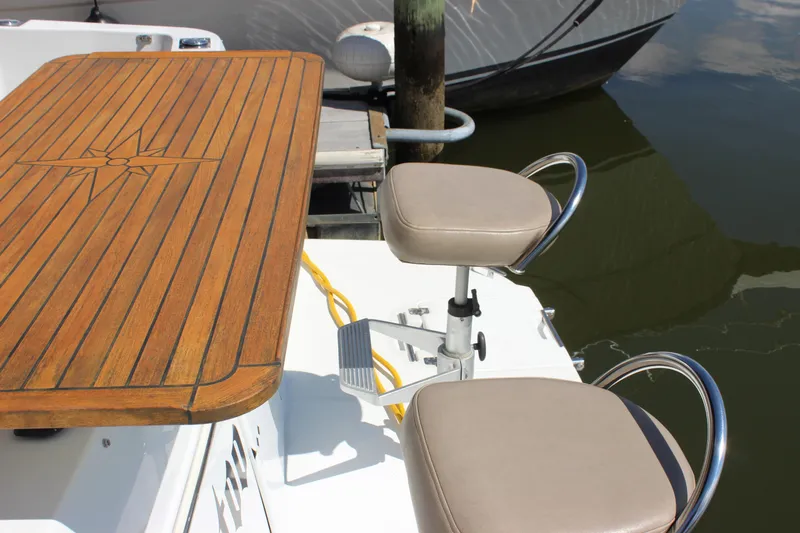  Yacht Photos Pics 2003 Carver 36 Super Sport boat with wooden deck and cushioned seats.